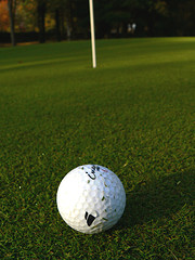 A golf ball and a hole.