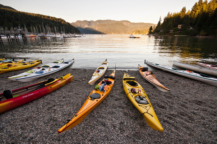 Colourful kayaks on the beach in Deep Cove
